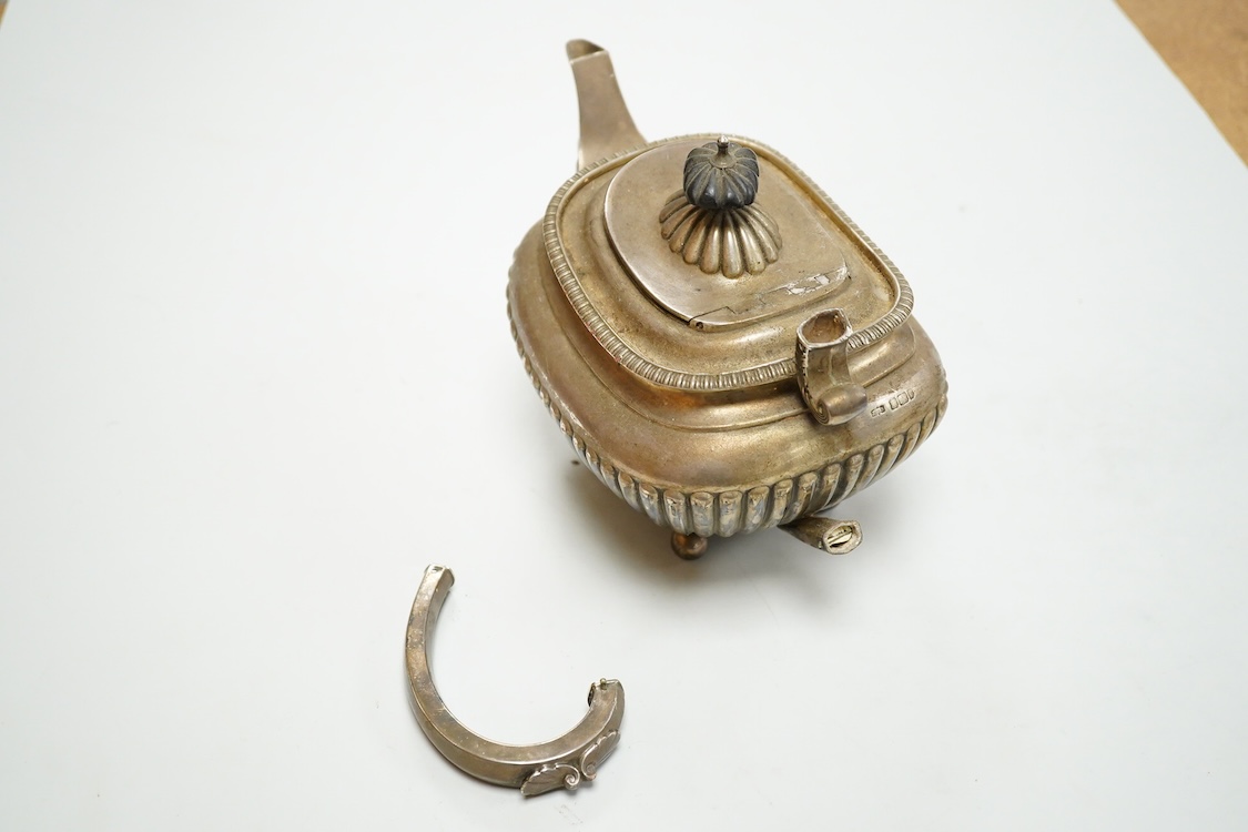 An early 20th century demi-fluted silver oval teapot, by James Dixon & Sons, Sheffield, 1903?, handle detached, together with a George III pierced silver oval salt, by Robert Hennell I, with glass liner(a.f.), gross weig